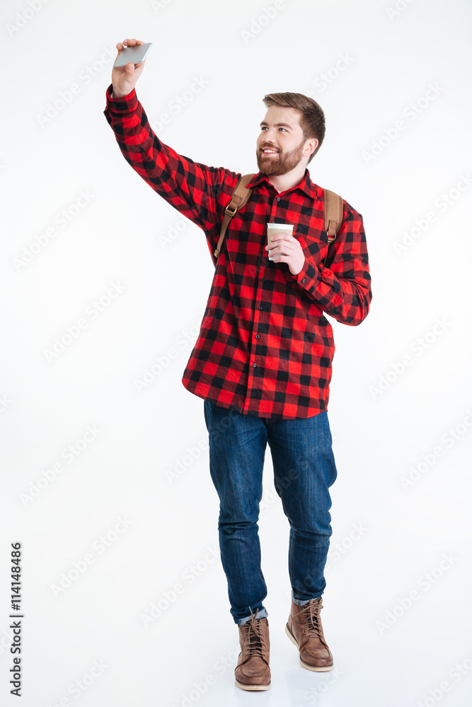 Man holding cup with coffee and making selfie photo Man holding cup with coffee and making selfie photo