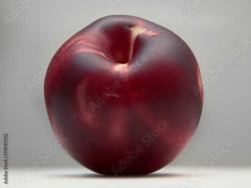 Close-up of red nectarine against white background