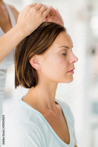 Cropped image of masseur giving massage to woman