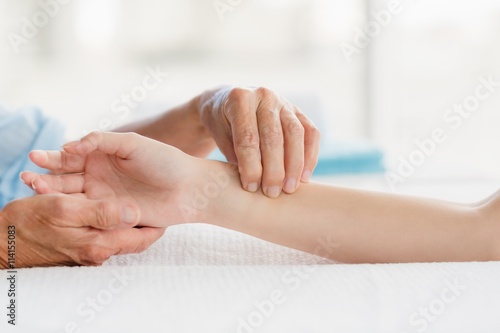 Obraz na plátne Cropped image of masseur giving hand massage to woman