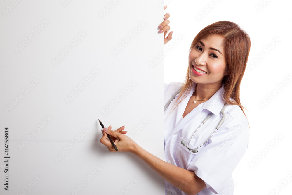 Young Asian female doctor peeking from behind blank sign point w Young Asian female doctor peeking from behind blank sign point w