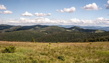 Hala na Malej Raczy mountain meadow in Beskid Zywiecki mountains with mountain ranges panorama and blue sky with clouds
