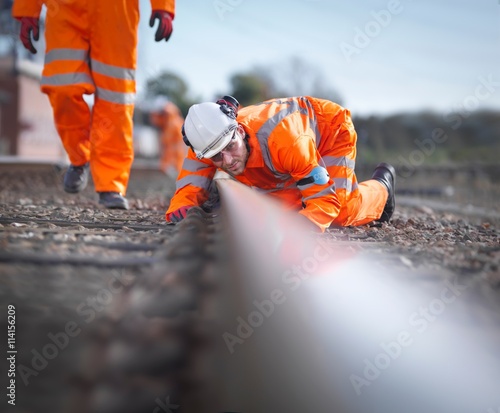 Railway maintenance workers inspecting track photo