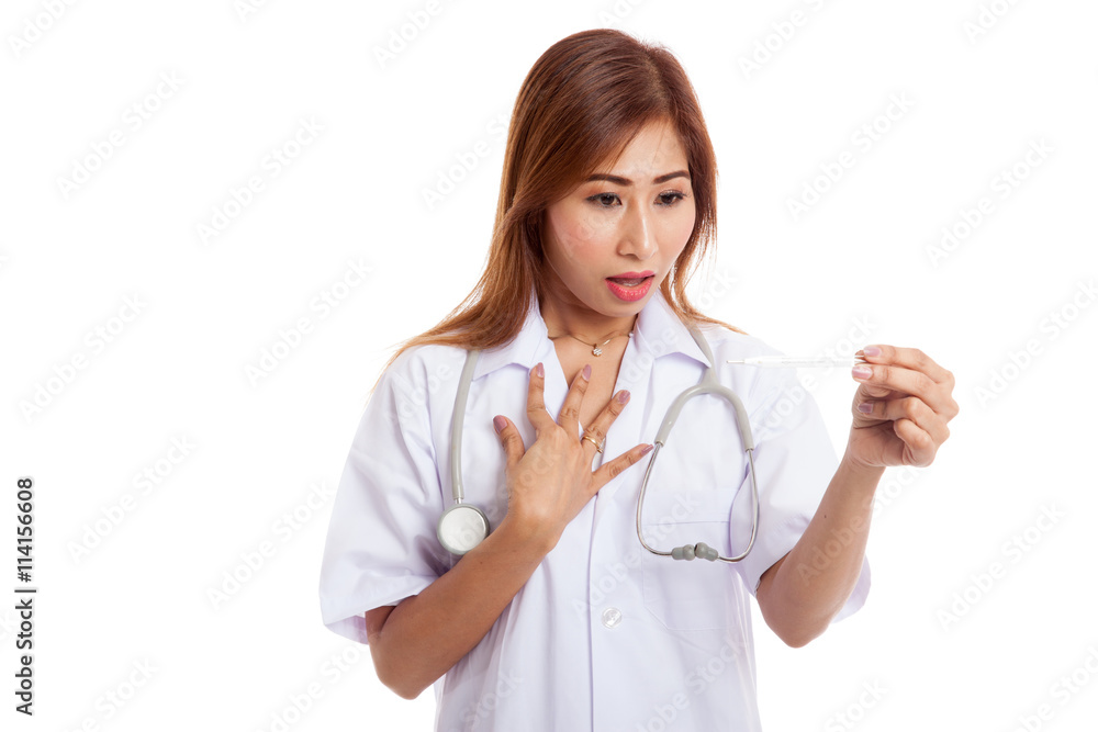 Young Asian female doctor worry look at thermometer Young Asian female doctor worry look at thermometer