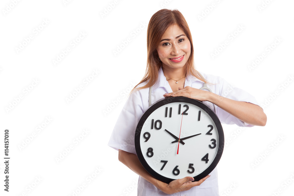 Young Asian female doctor happy show a clock Young Asian female doctor happy show a clock