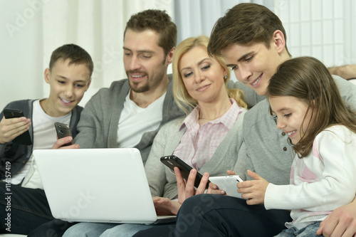 happy family with electronic gadgets