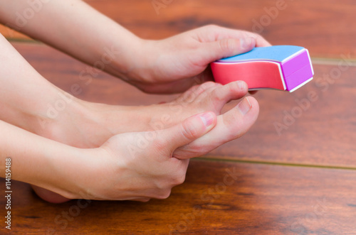 After cutting and file the nails is neccesary to smooth the foot, colored tool photo