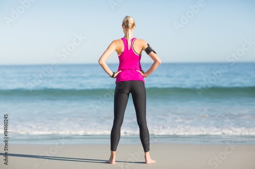 Sportswoman standing on beach