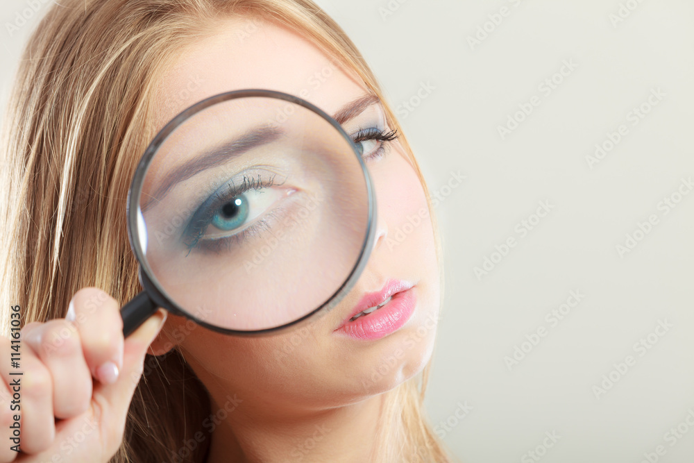 girl holding on eye magnifying glass loupe girl holding on eye magnifying glass loupe