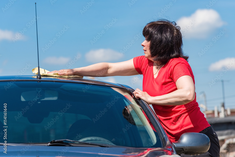 brunette woman washes her car