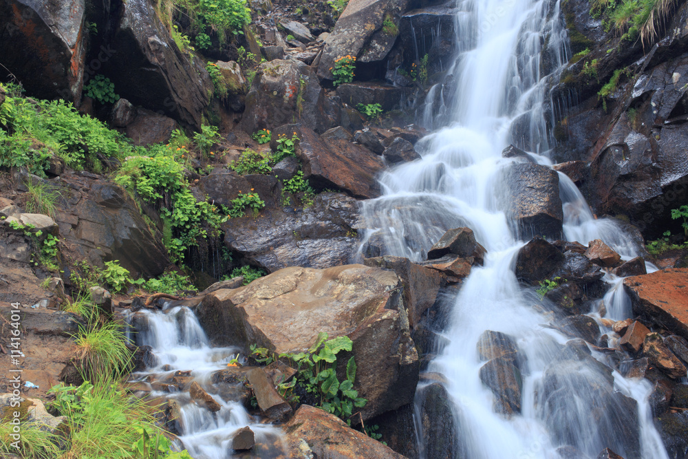 Beautiful waterfall in the mountains during the summer. Beautiful waterfall in the mountains during the summer.