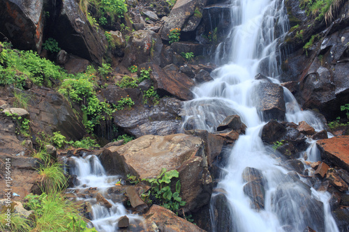 Beautiful waterfall in the mountains during the summer.