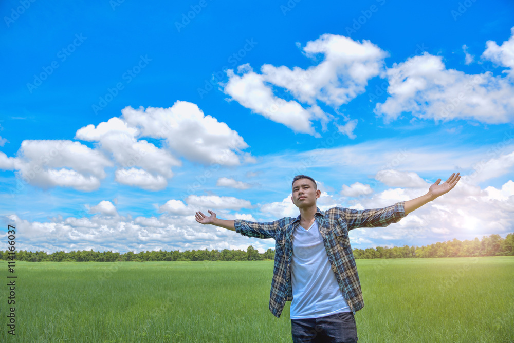 Young man having happy time in nature with copy space on meadow Young man having happy time in nature with copy space on meadow