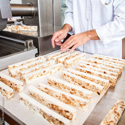 Photos nougat portions on white paper in industrial stainless steel laboratory