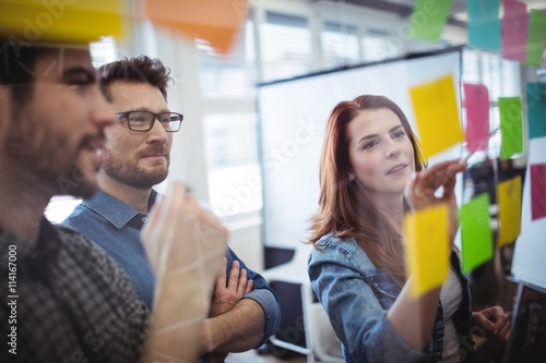 Business people planning with adhesive notes in office photo