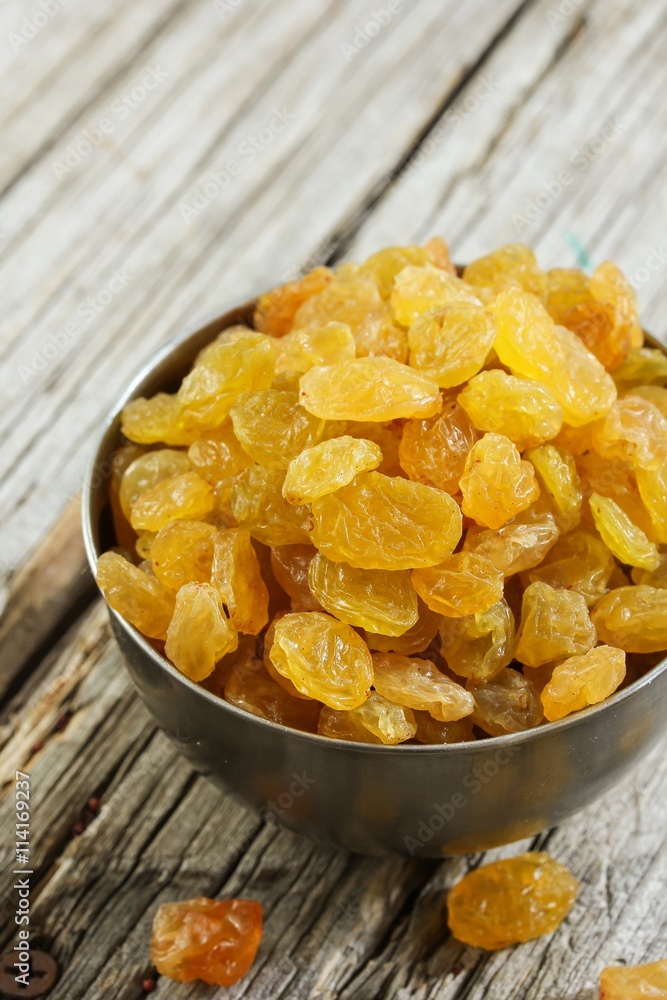 Dried Golden Raisins in a bowl, selective focus Dried Golden Raisins in a bowl, selective focus