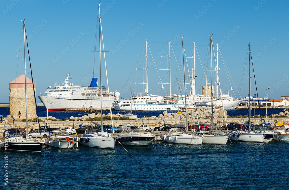 Cruise ship and yacht in the bay of Mandraki. Rhodes, Greece