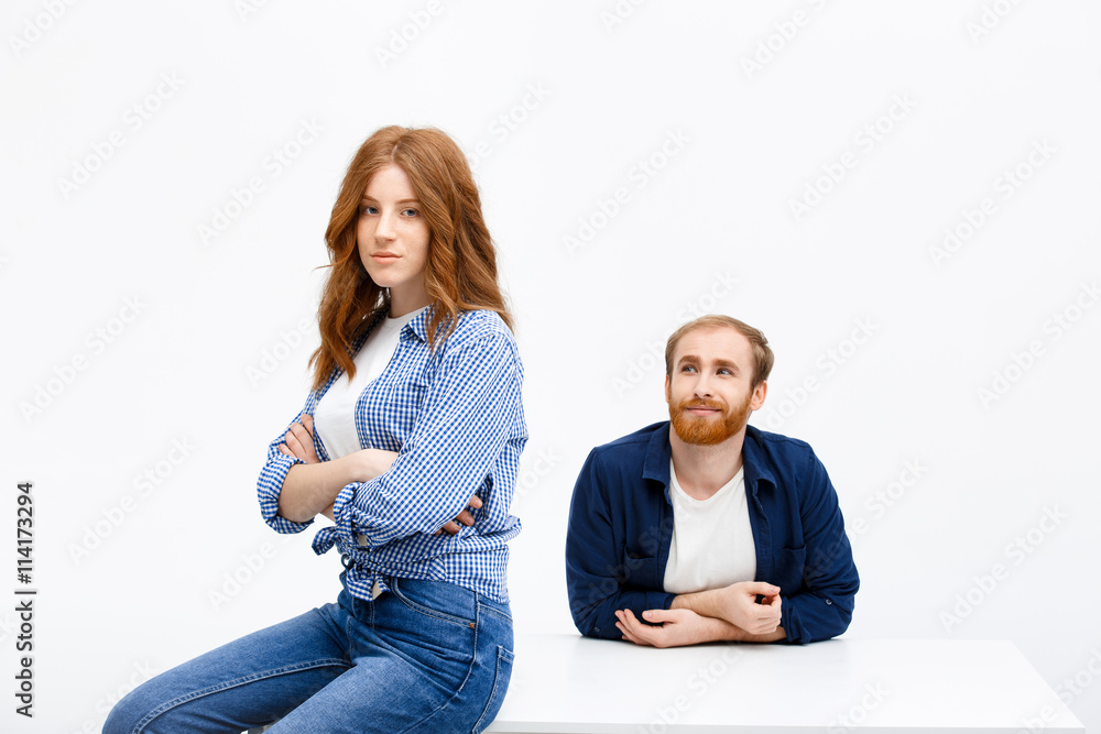 Beautiful redhead girl and boy posing over white background near Beautiful redhead girl and boy posing over white background near