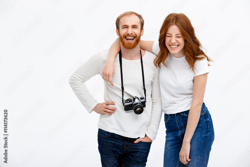 Redhead photographer dressed in white jacket standing near redhe Redhead photographer dressed in white jacket standing near redhe