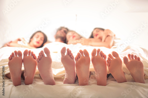 Man sleeping with three women photo