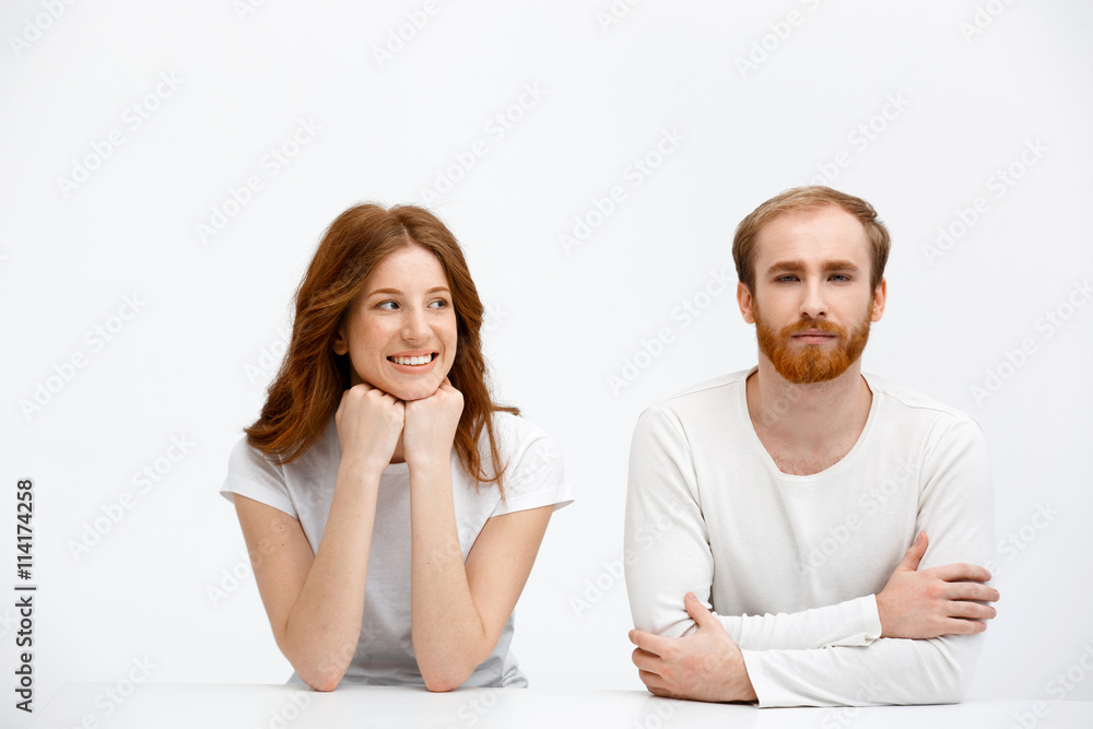 Tenderless redhead girl and boy smile sitting at white desk Tenderless redhead girl and boy smile sitting at white desk