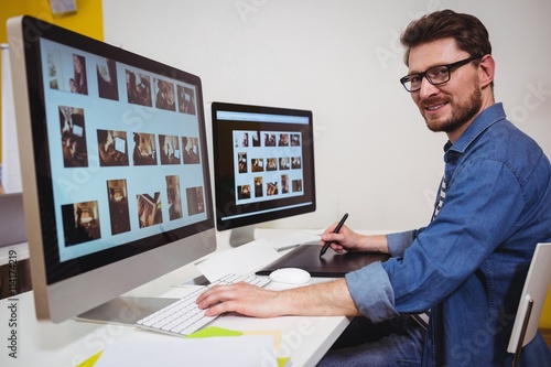 Portrait of male photo editor working on computer 