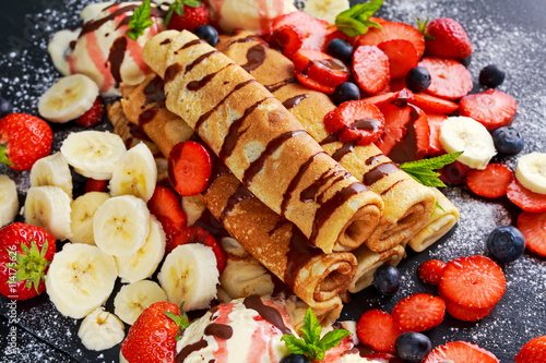 Sweet Rolled Pancakes with nutella, strawberry, blueberry, banana, ice cream.