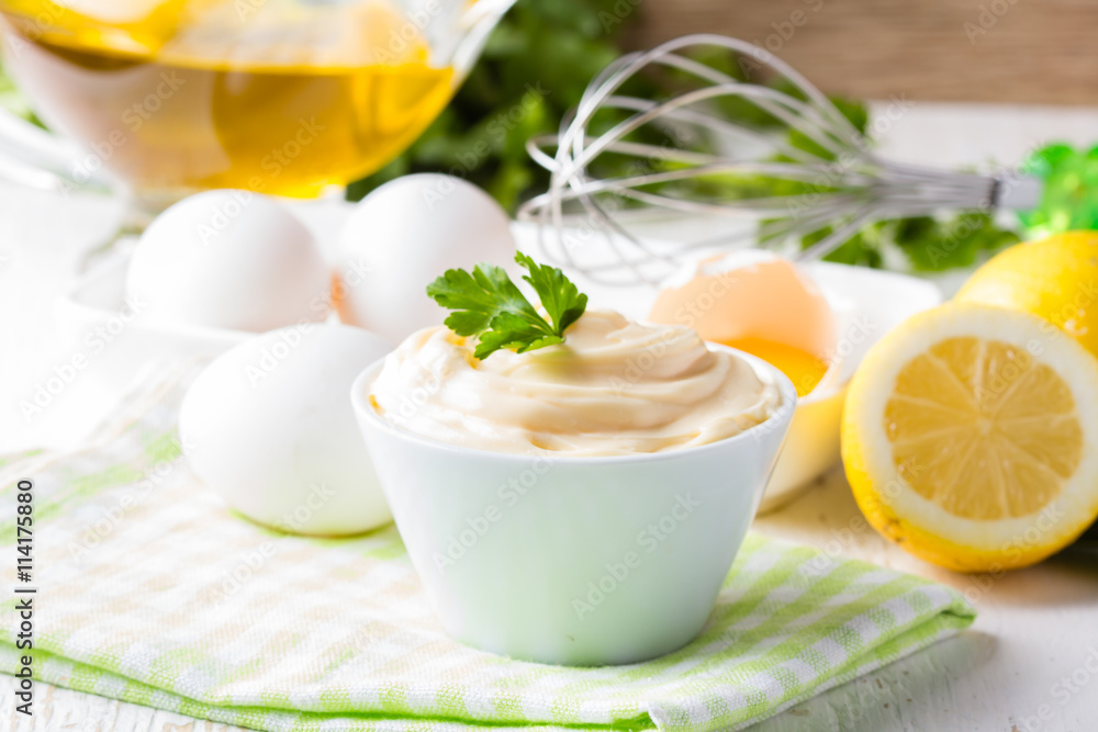 Fresh homemade Mayonnaise and ingredients on white background Fresh homemade Mayonnaise and ingredients on white background