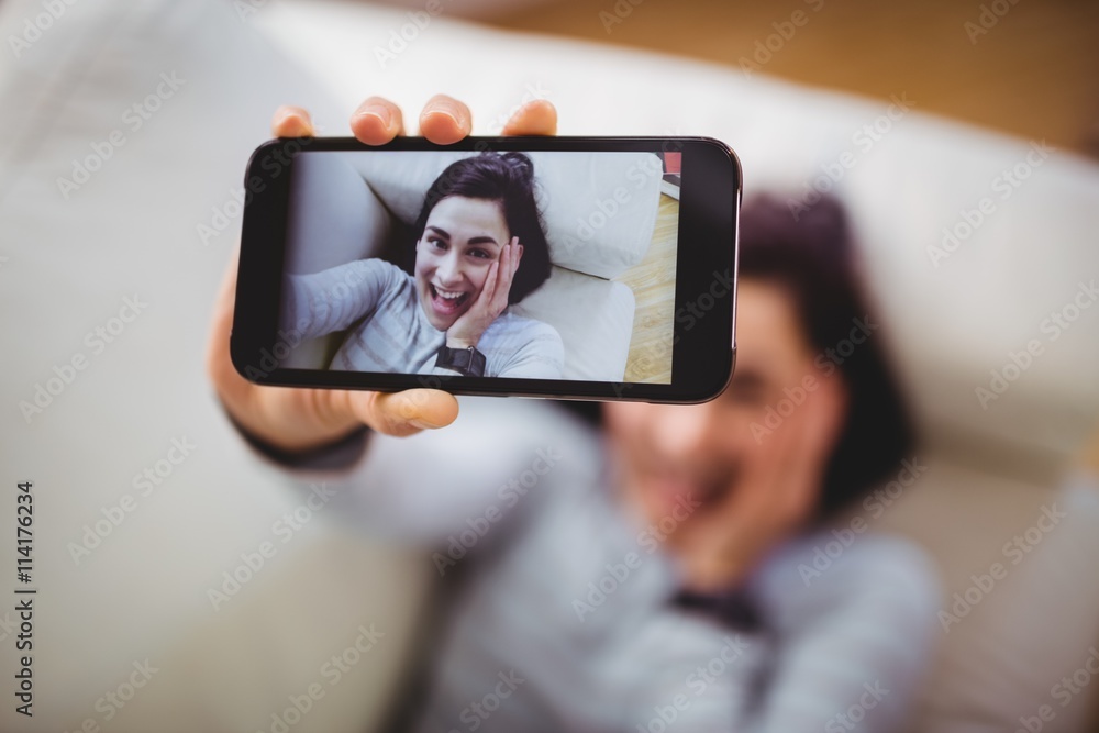 High angle view of happy woman taking selfie