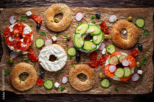 Delicious Bagel sandwiches with soft cheese, chorizo and vegetables