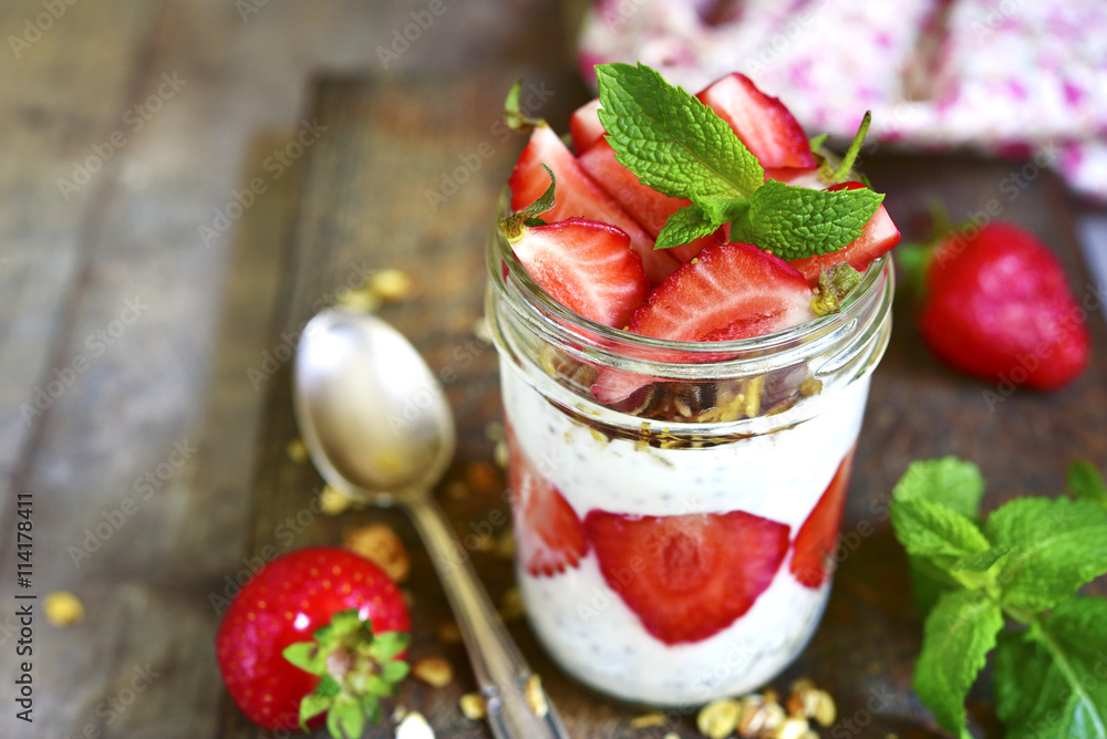 Healthy layered dessert with chia pudding,granola and strawberry Healthy layered dessert with chia pudding,granola and strawberry