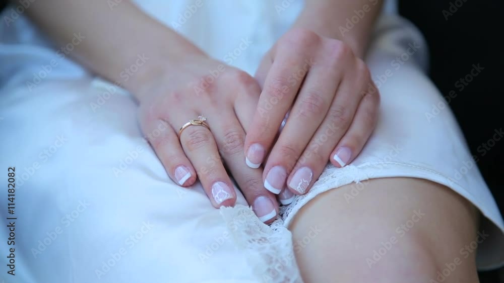 Bride's hands are touching the ring Bride's hands are touching the ring