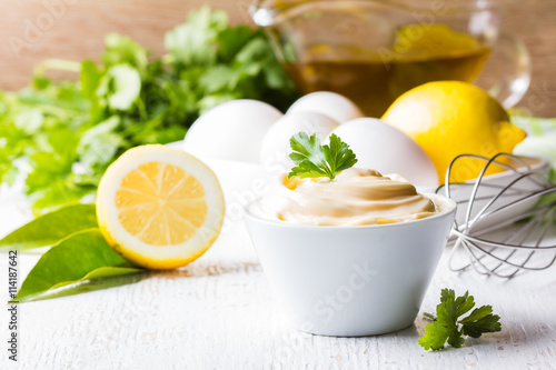 Fresh homemade Mayonnaise and ingredients on white background