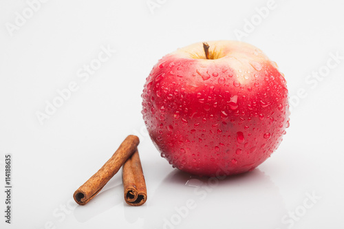 red apple and cinnamon isolated on white
