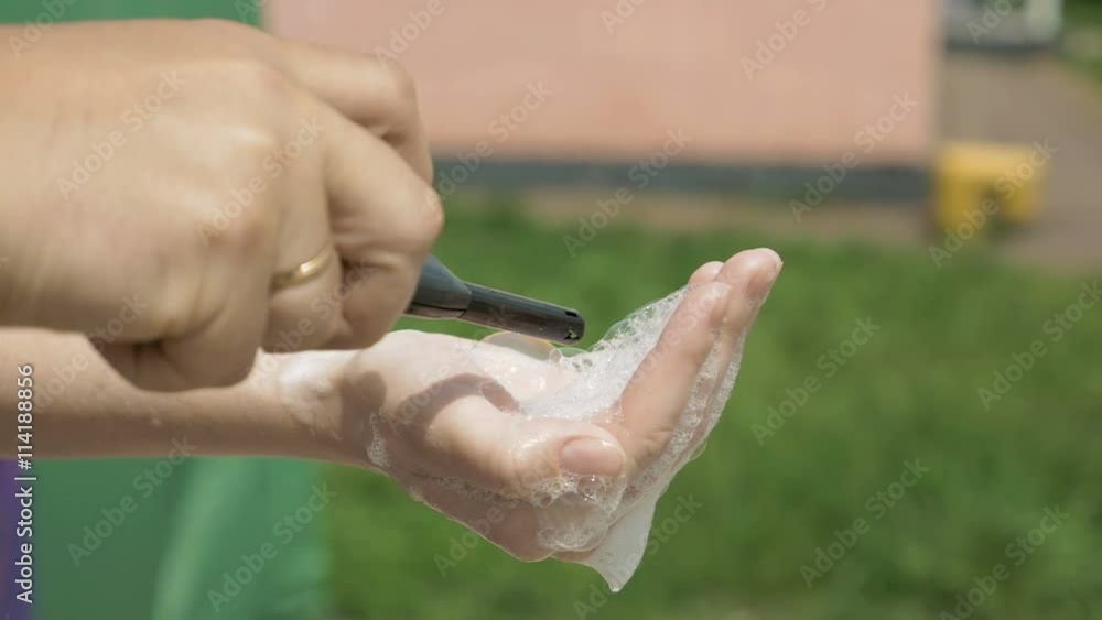 A hand with soapy water mixed with flammable substance is set on fire