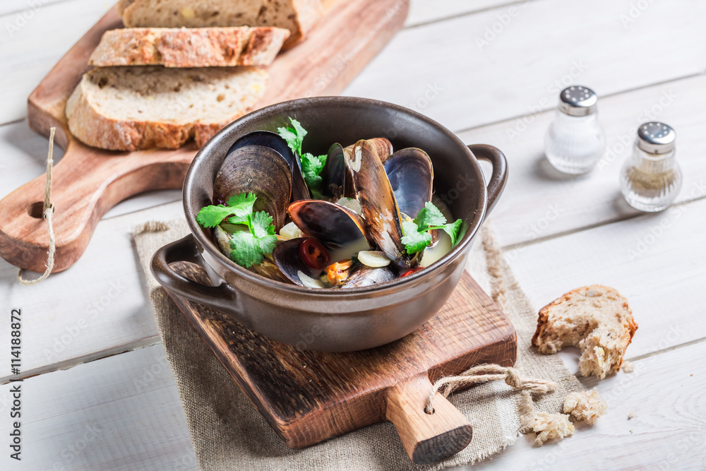 Tasty mussels with garlic and red peppers served with bread