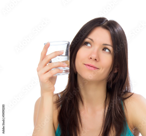 Young happy woman drink glass of drinking water and looking at t