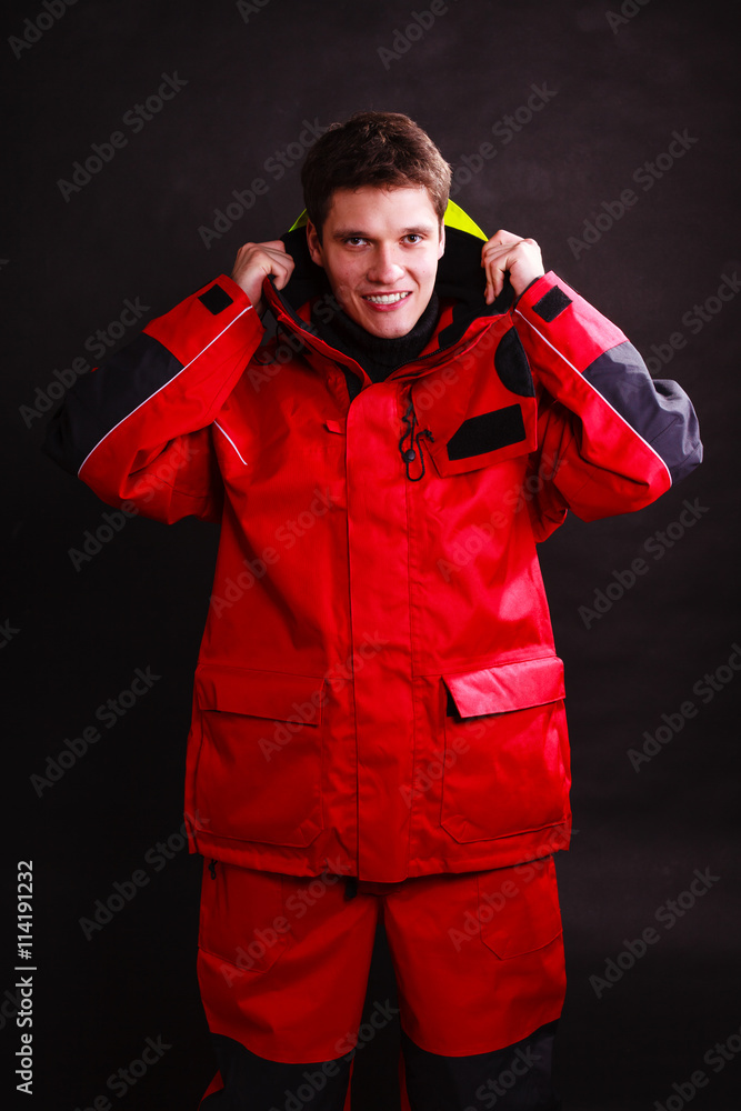 Fototapeta premium Young man putting on hood