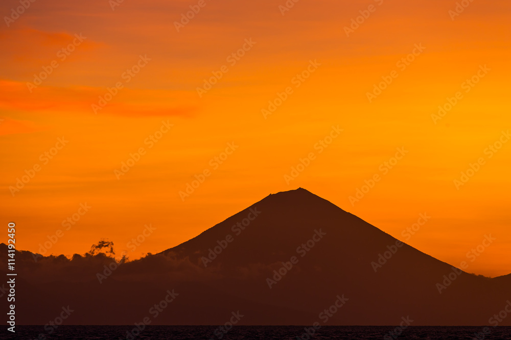 Sunset view on Gunung Batur volcano on Bali from Gili Travangan island, Indonesia