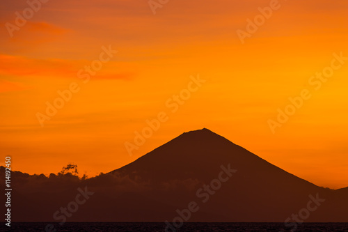 Sunset view on Gunung Batur volcano on Bali from Gili Travangan island, Indonesia