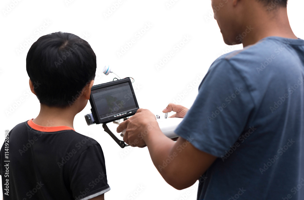 Father and son controlling a remote drone helicopter with LCD pr Father and son controlling a remote drone helicopter with LCD pr