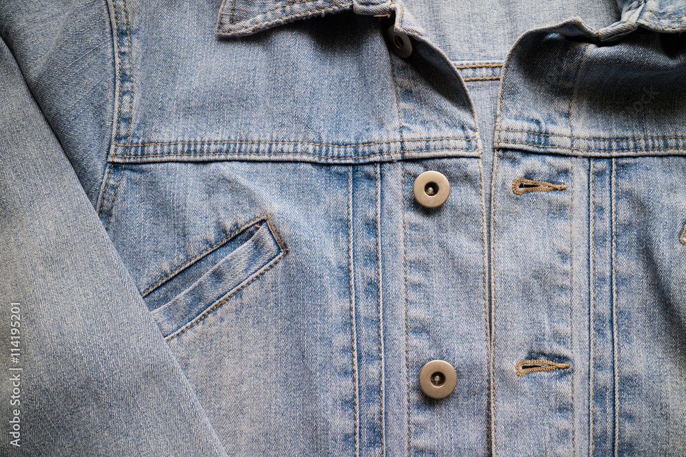 Close up aged denim texture. Old blue jeans jacket with stiched Close up aged denim texture. Old blue jeans jacket with stiched