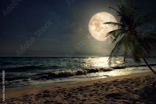 Beautiful fantasy tropical beach with Milky Way star in night skies, full moon - Retro style artwork with vintage color tone (Elements of this moon image furnished by NASA)