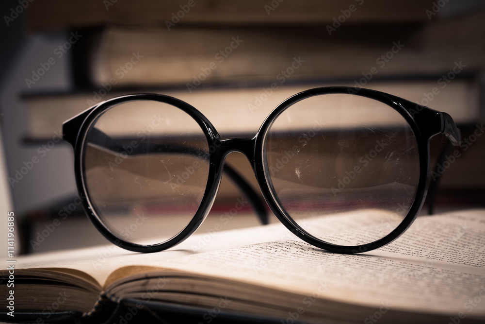 Reading table with tablet PC and old book and eyeglasses Reading table with tablet PC and old book and eyeglasses