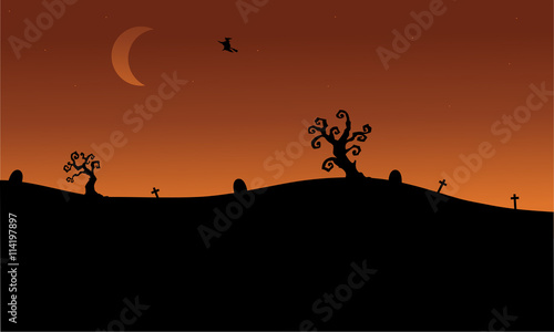 Halloween witch flying in tomb silhouette