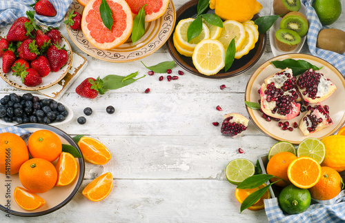 Healthy eating background. Different fruits and berries on  wood