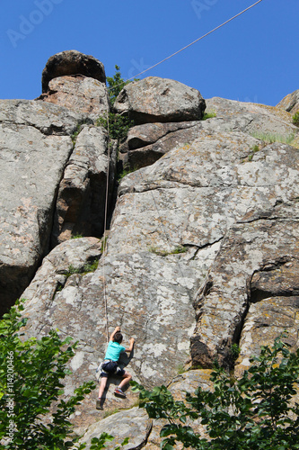 Boy climbing on the rock
