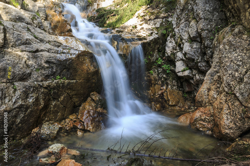 Waterfall over limestone rocks in the Carpathians