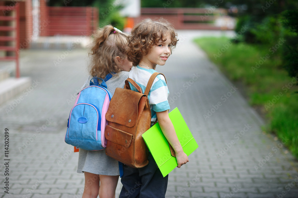 Αυτοκόλλητο Two little pupil of elementary school, boy and girl, stand having joined hands