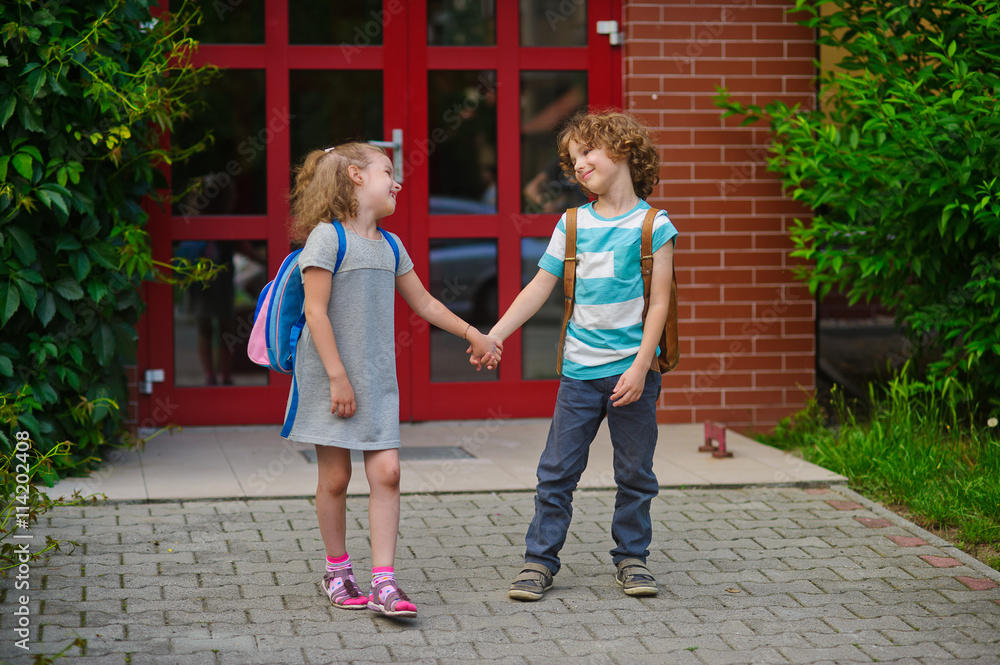 Little school students go on a schoolyard holding hands. Stock Photo ...